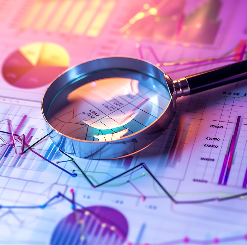 magnifying glass on papers showing graphs