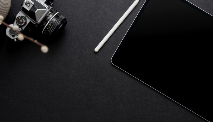 digital tablet and camera on a desk