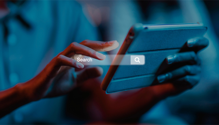person typing on hand held digital tablet